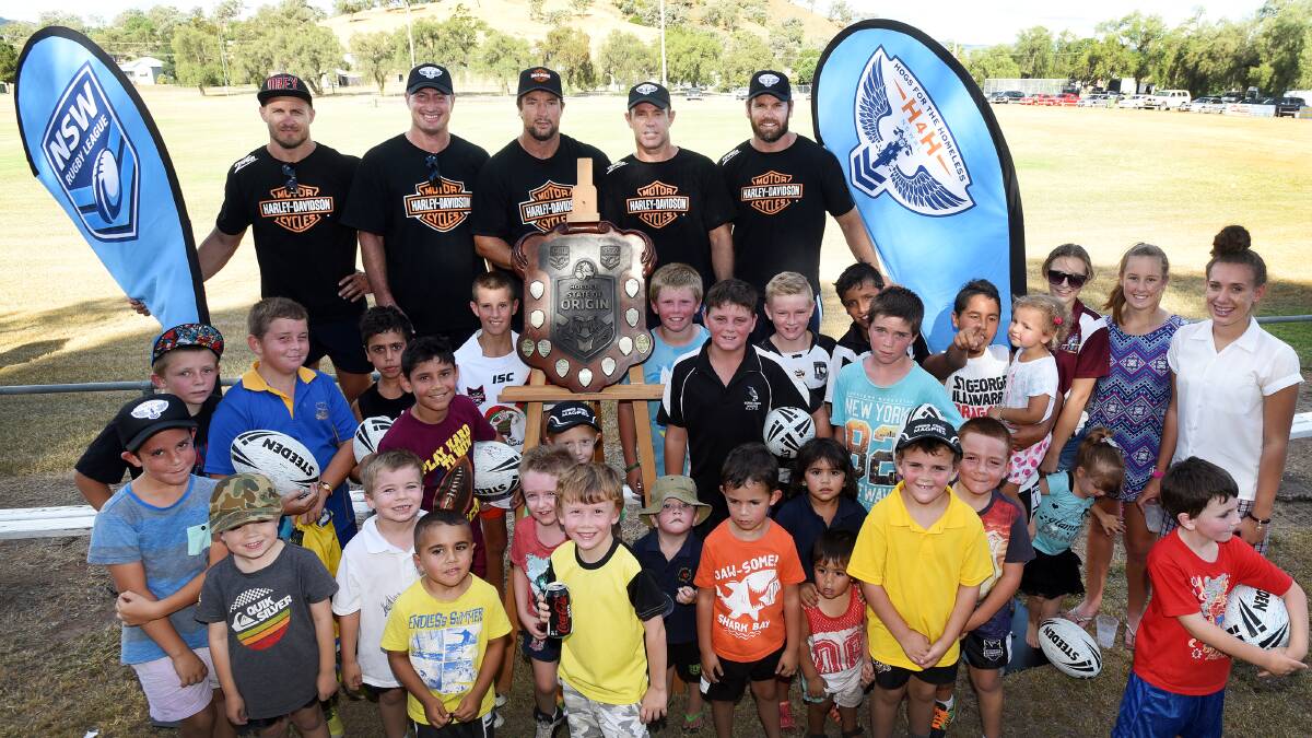 Raising some hog fun in Werris Creek Magpie territory yesterday were (back from left) Matt Cooper, Steve Menzies, Nathan Hindmarsh, Brad Fittler and Josh Perry and some of their new best friends. Photo: Gareth Gardner  230215GGE02