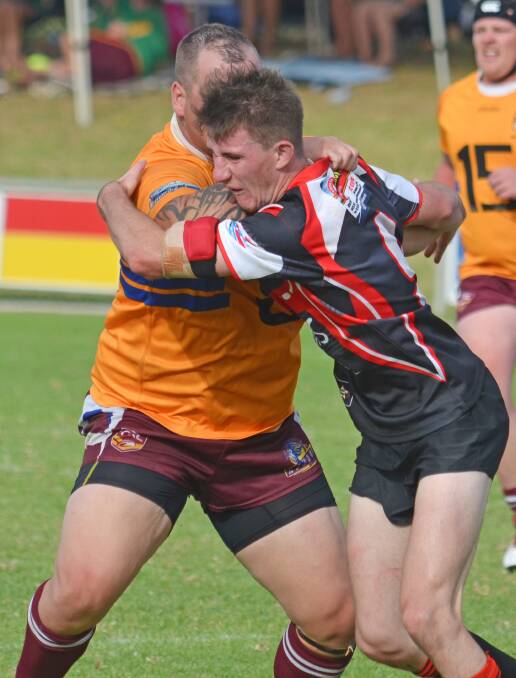 Wests Lions captain Chris Vidler can't quite shake Norths hooker 
Callum Hayne off with the pair having a running battle in the final of the Wests Knockout in Gunnedah. Photo: Chris Bath 290315CBA46