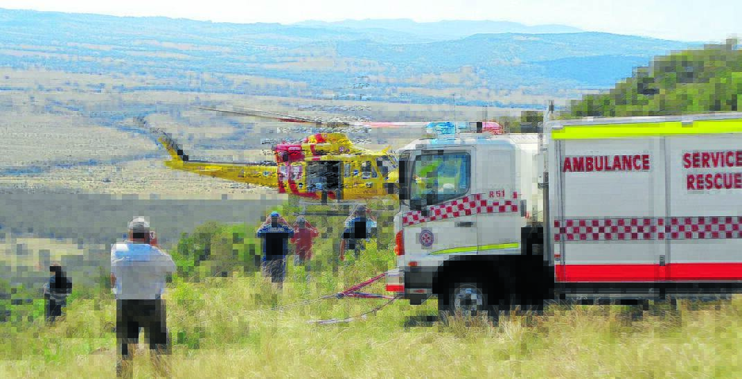 SAFE AND SOUND: The Newcastle-based Westpac rescue helicopter winched a paraglider from Mt Borah yesterday. Photo: Godfrey Wenness