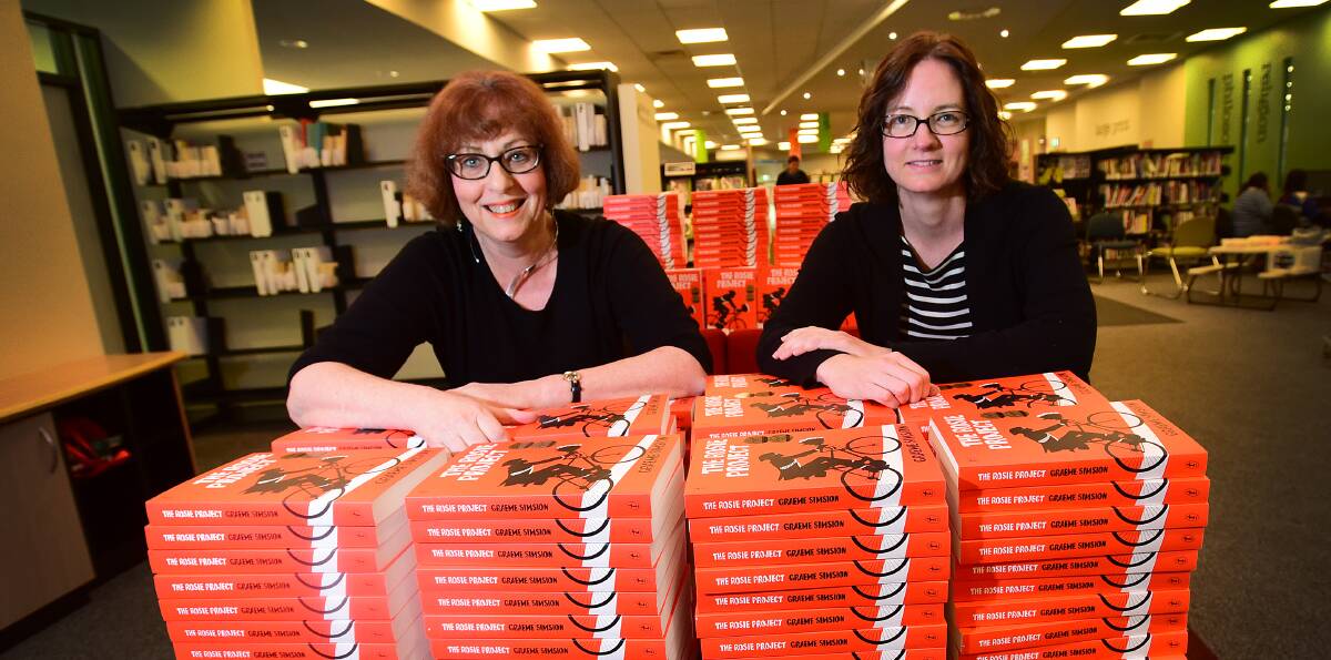 ON THE SAME PAGE: Central Northern Regional Library will distribute 300 copies of The Rosie Project to entice readers to get back into books, or perhaps venture into the world of the imagination. Library manager Kay Delahunt, left, and information and collections librarian Shiralee Franks show off part of their stash of The Rosie Project. Photo: Gareth Gardner 060715GGE05