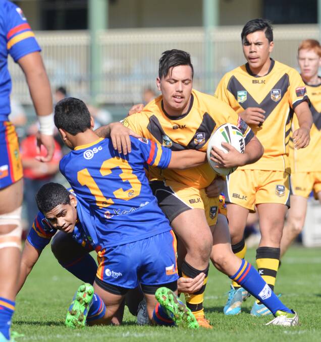 WA prop Rakheem Tuuta-Edwards crashes into the South Australian defence. He was one of his side's stars in the big win in the opening game of the Under 15 schoolboy championships. Photos: Barry Smith 220614BSA06