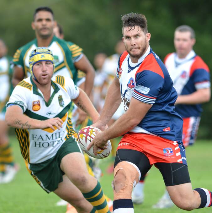 Kootingal captain-coach Nathan Hamlin looks to put a support through a hole in Saturday’s win over Bendemeer at Bendemeer Oval. Nathan Flynn is the Mountain Man covering in defence. Photo: Barry Smith 050414BSE09
