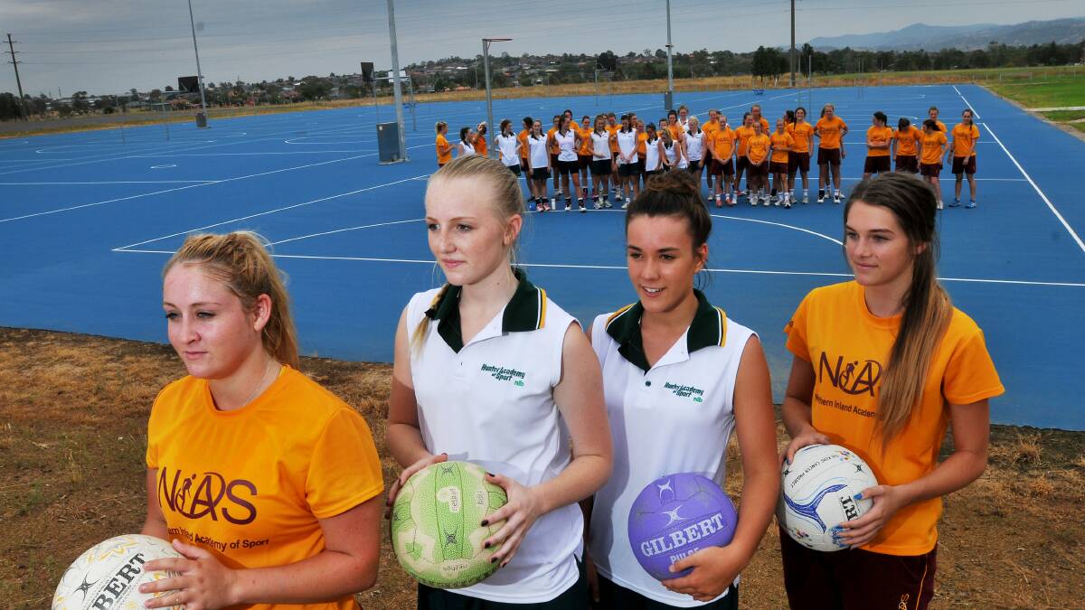 The NIAS netball girls joined up with the Hunter squad for a training weekend in Tamworth on the weekend. Pictured are NIAS’s Tayla Fuller (far left) and Kaitlin Discoll (far right) with Hunter counterparts Jamie Wakefield (second from left) and Tim Trayhurn with the two squads in the  background. Photo: Gareth Gardner  150214GGA01