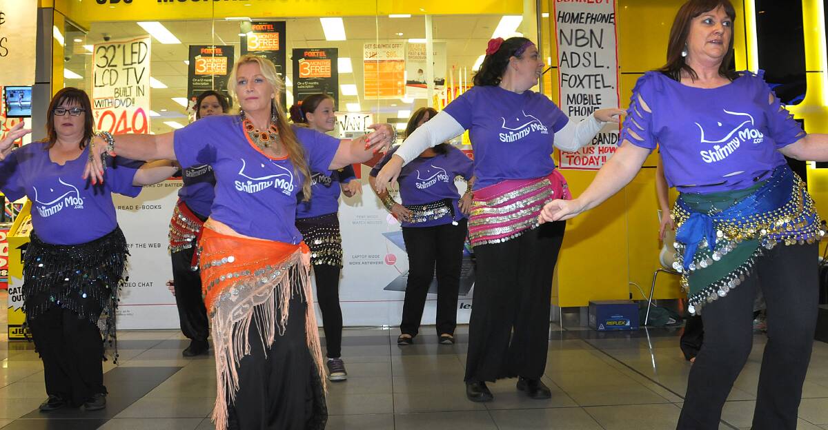 VITAL MOVEMENT: Belly dancers perform in front of a crowd of curious diners at Centrepoint in Tamworth to raise money to help local refuge services support victims of domestic violence. Photo: Geoff O’Neill 100514GOD01