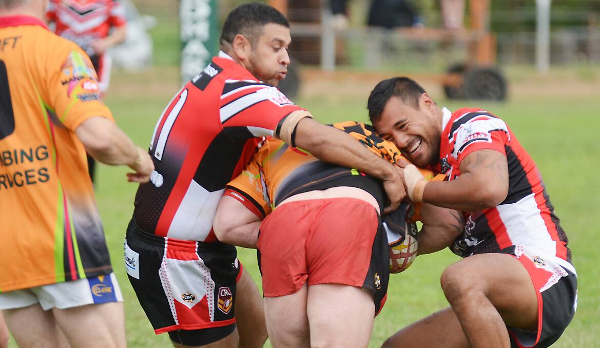 North captain Marshall Barker (left) and Ky Ruru wrestle a Diggers player to the ground during the 104-point drubbing on  Saturday. Photo: Christopher Bath 030514CBA05