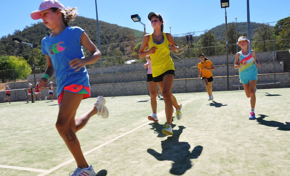 NIAS tennis hopefuls run the court in last weekend’s intensive session. Photo: Geoff O’Neill 080214GOA02