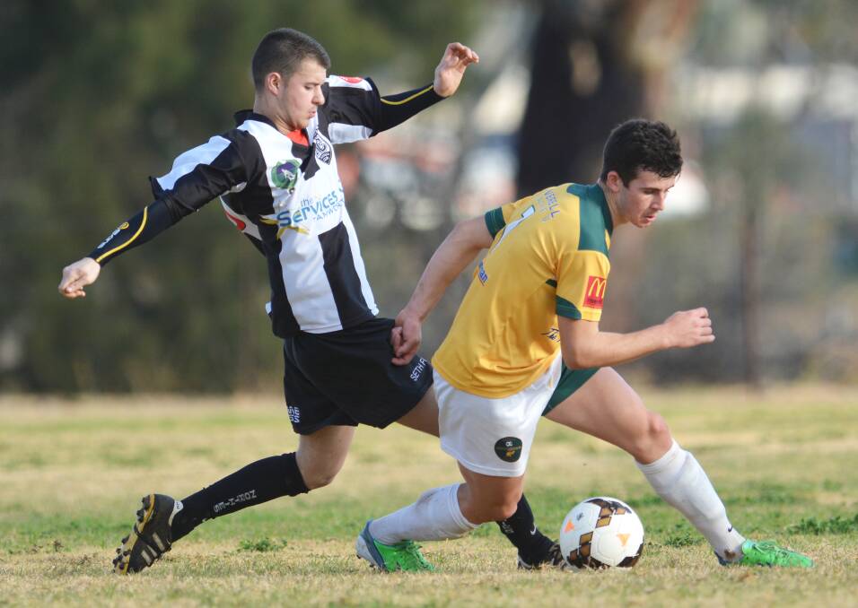 Young guns Will Kam (left) and Callum Dolby go at it during a North Companions-Joeys FC match back in July. Photo: Barry Smith 260714BSB40