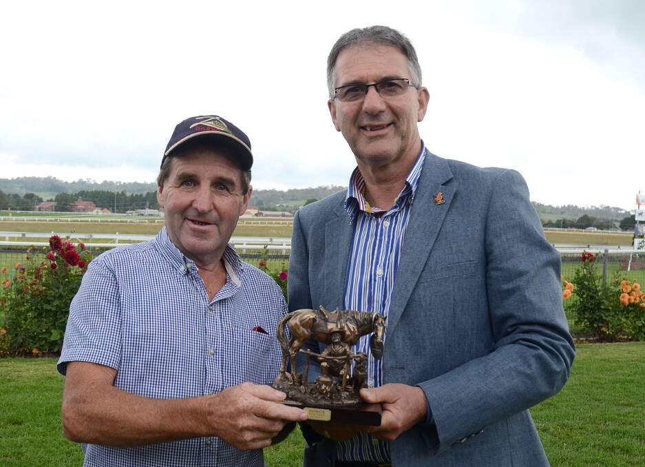 Walcha Cup Prelude-winning trainer Paddy Cunningham (left) receives the Armidale Citiizen of the Year Walcha CupPrelude trophy from Armidale citizen of the year Phil Wheaton. Photo: pixonline.com.au
