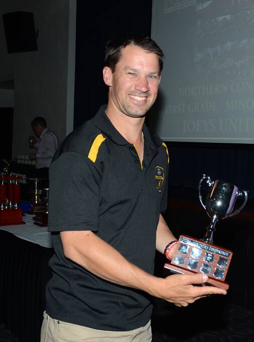 Inverell Joey’s FC captain-coach Steve Gadd with their Northern Conference minor 
premiership trophy.