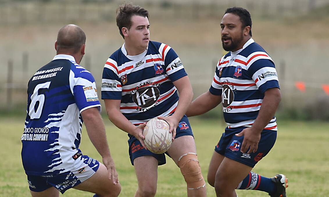 Kootingal Rooster pivot Jordan Sharpe looks for options as Amos Ioasa moves past and Barraba five-eighth Luke Cox has some defensive decisions to make. Photo: Geoff O’Neill 030515GOE02