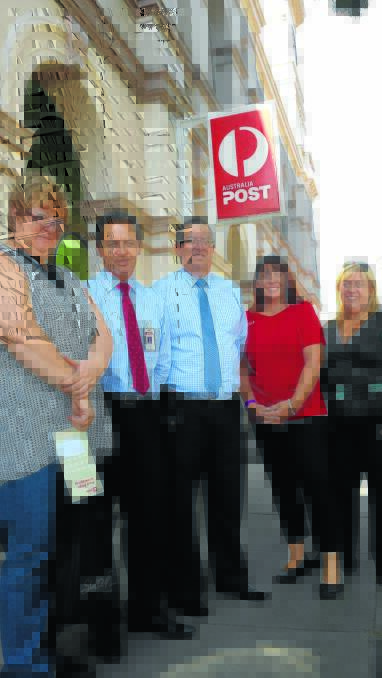 FEEDBACK: Australia Post customer Jenny Mason gets the lowdown on changes within Australia Post from postal executives David Ife, David Smith, Tamworth branch manager Tracey Lange and Catherine Carroll outside the Tamworth Post Office yesterday.