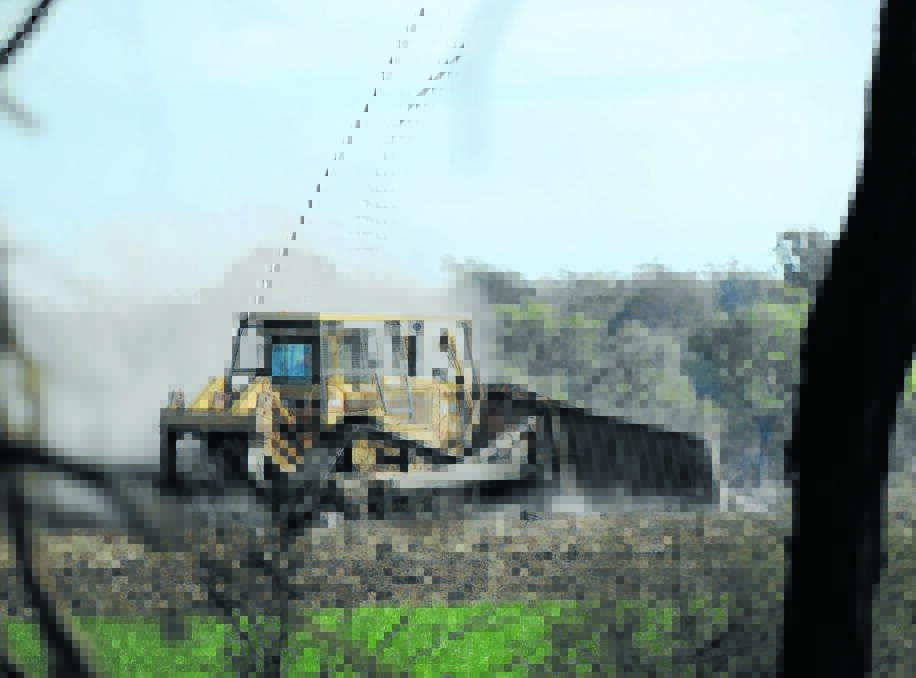 MESSY SITUATION: An excavator carries out work this week on a Croppa Creek property at the centre of a bitter dispute over native vegetation laws. Accused murderer Ian Robert Turnbull and his grandson Cory Ian Turnbull face fresh allegations of illegal land clearing.