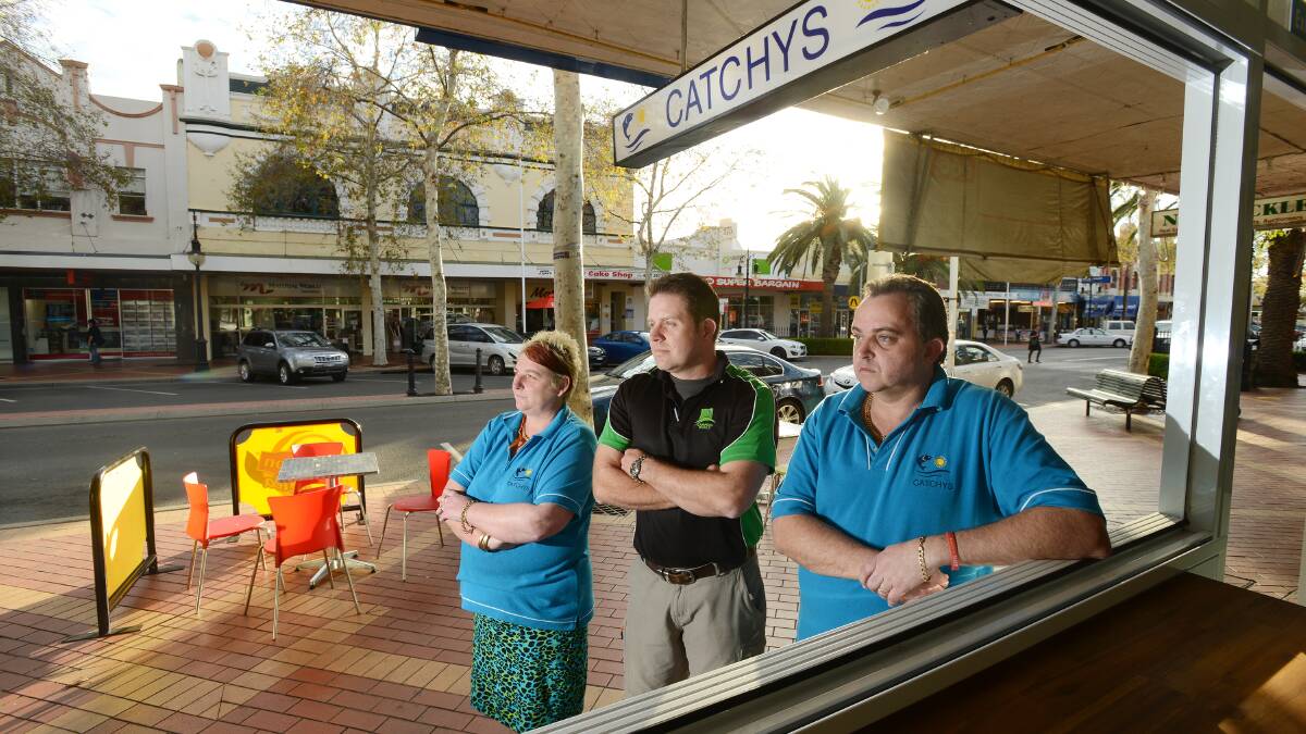 WRONG NOTE: Peel St business owners Michelle Hutchins, Roger Cupples and Brett Hutchins are outraged at plans to keep the block between Brisbane and Bourke streets open to traffic during the country music festival. Photo: Barry Smith 190914BSC04
