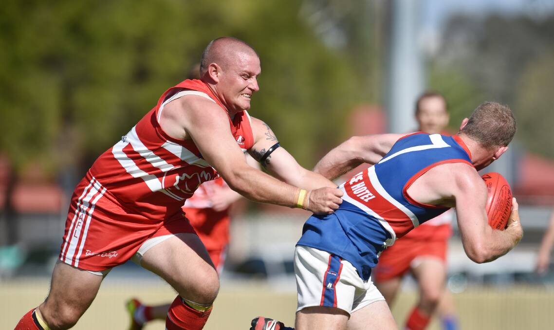 Swans president Josh McKenzie grimaces as he tries to snag Gunnedah star Andrew George in their first-round clash. Today, McKenzie and the Swans face the might of the New England Nomads while George and the Bulldogs head to Moree.  Photo: Barry Smith 110415BSC21