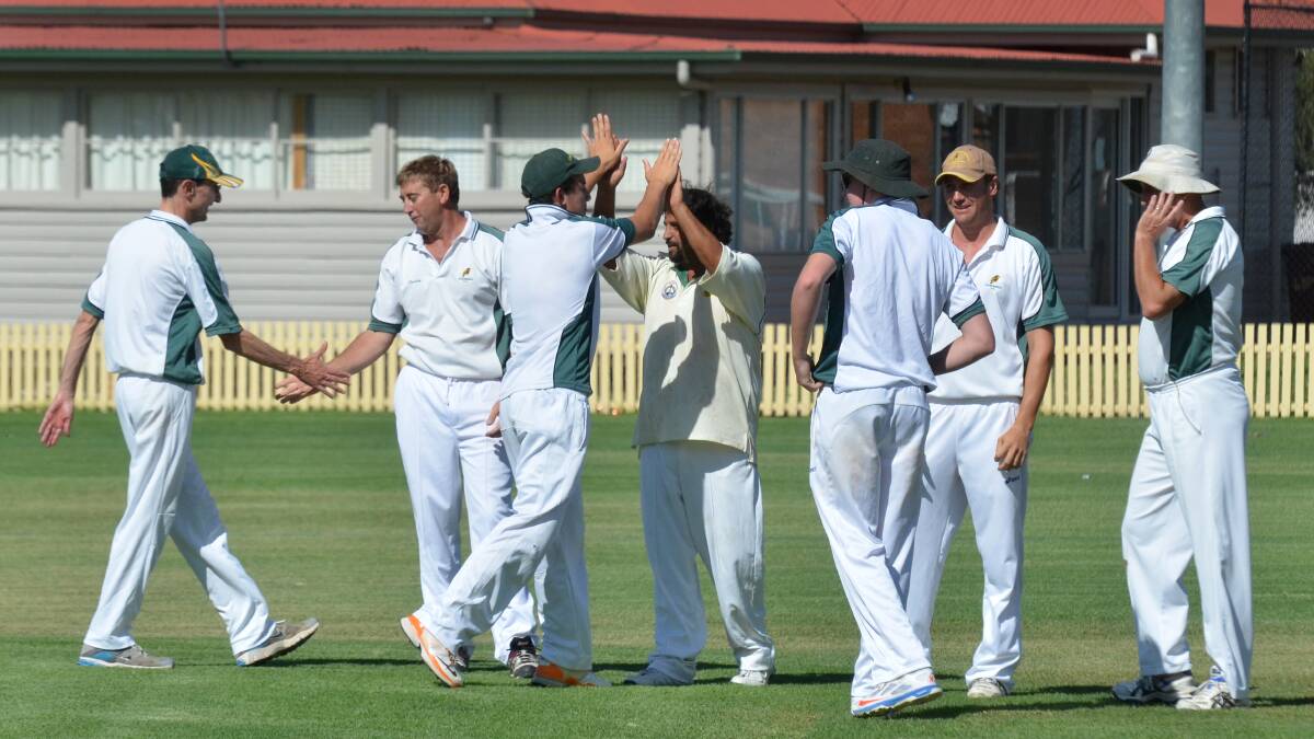Kookaburras celebrate an Albion wicket on Saturday. 220314CBA03