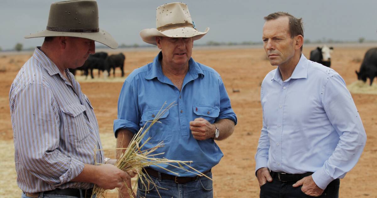 PROMISING RELIEF: From left, Agriculture Minister Barnaby Joyce, grazier Phillip Ridge, of Jandra near Bourke, with Prime Minister Tony Abbott as part of a drought tour. Photo: Andrew Meares