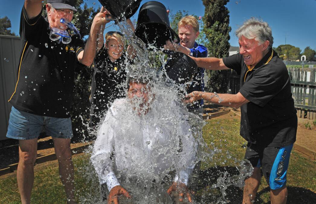 MAKING A SPLASH: Tamworth MP Kevin Anderson (front) cops a ‘bucketing’ from 88.9FM afternoon announcer Terry Lane, morning announcer Leisa ‘LJ’ Norris, The Northern Daily Leader editor Daniel Johns and 88.9FM drive announcer Ray McCoy as part of the Ice Bucket Challenge. Photo: Geoff O’Neill 230914GOC01