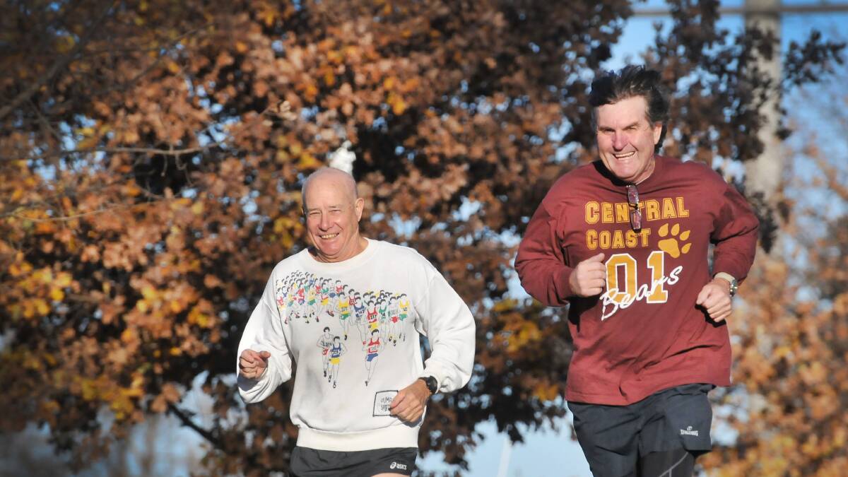 ON THE RUN: Tamworth grandfather of six Spencer Hird, left, with jogging partner Chris Ball, is determined to ‘run his age’ at next month’s City2Surf. Photo: Gareth Gardner 090714GGD02