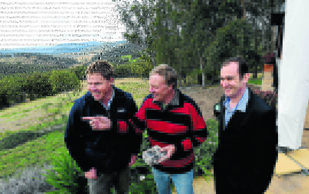 TURNING THE TABLES: Meat and Livestock Australia’s Alex Ball, Walcha farmer Rob Blomfield and University of New England’s Dr Greg Falzon inspect the cutting-edge technology that could reduce wild dog attacks. Photo: Gareth Gardner 260615GGB14