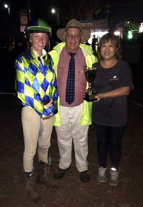 Winning owner Cindy Poulos with jockey Jess Towns and Moree Show Society president John Appleby after winning the North-West Plumbing Moree Camel Cup on Saturday.
