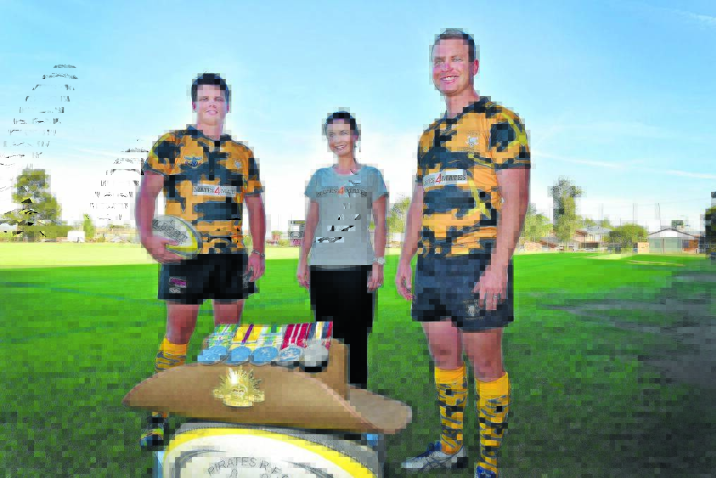 HELPING OUT: From left, Pirates’ Tim Collins, Kate Wynne and Andy Wynne have been the driving force behind a fundraiser for Mates4Mates to coincide with today’s local derby. Photo: Geoff O’Neill 160415GOF02