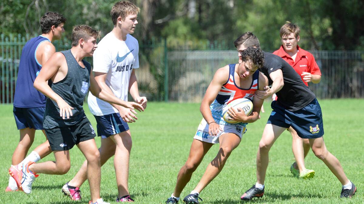 Moree’s Percy Duncan is caught by Quirindi’s Ben Douglas during this attacking drill as (from left) Will Morley (Narrabri), Jack Foley (Barraba), Damon Steel (Narrabri) and Lochie Urquhart (Tamworth) look on. Photo: Samantha Newsam 210215SA01