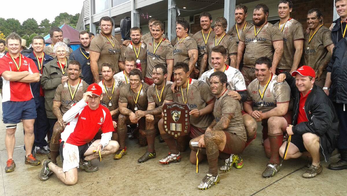 A muddy Central North opens celebrate their Richardson Shield win.