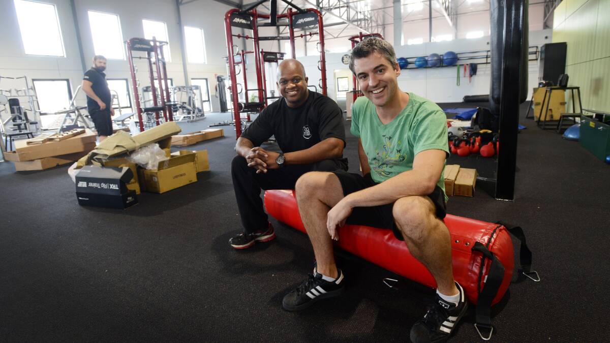 ALMOST HERE: 360 Fitness owners Dwone Jones and Jay Lynch busily prepare for the grand opening of their new heath and indoor acquatic centre. Photo: Gareth Gardner 240314GGA01