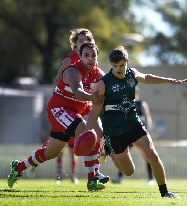 New England Nomad star Jed Ellis-Cluff leads  the chase from Swans  Trumaine Rankmore and Lachlan Pallott in Saturday’s TAFL clash. Photo: Gareth Gardner  090515GGF04