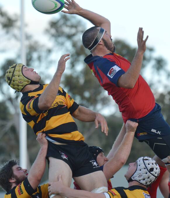 This ball just goes over the top of Gunnedah’s Lincoln Stewart as Pirates’ Blake Pollock gets ready to profit behind during their clash on Saturday.  Photo: Samantha Newsam 120714SNA03