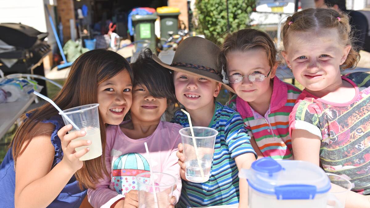 REFRESHING: From left, Bea Navarro, Francine Bage, Liam Dahl, Isabella Norman and Chloe Vera serve ice-cold lemonade to parched voters from their stall on Gunnedah Rd. 280315GOA31