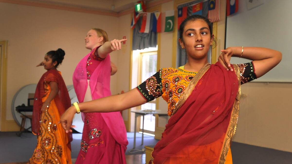 GRACEFUL: From left, Indian dancers Impana Dayananda, Larissa and Vineesha Veer entertain seniors at yesterday’s multicultural gathering. Photo: Geoff O'Neill 200314GOB01