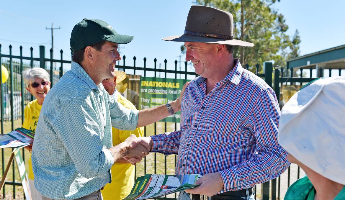 HELPING HAND: Nationals MP Kevin Anderson thanks New England MP Barnaby Joyce for handing out how-to-vote cards on Saturday. Photo: Geoff O’Neill 280315GOA21
