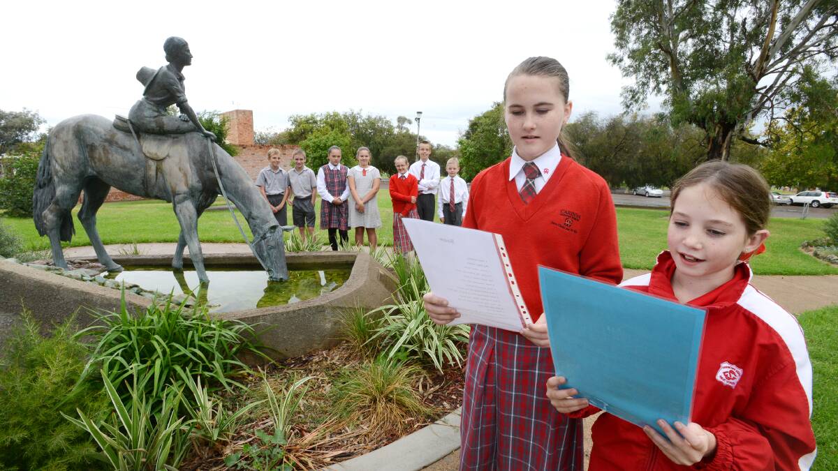 RECITING NEAR DOROTHEA’S STATUE: The 30th anniversary of the Dorothea Mackellar Poetry Awards will also feature a two-week festival celebrating this milestone year. Carinya Christian School Gunnedah students Aimee Crookal, left, Year 6, and Madi Simson, Year 5, read their entries with Zac Griffin, Zac Clarke, Keesha Thompson, Lucy Merlehan, Lara Hewitt, Kai Sanders and Caleb Austin behind. Photo: Barry Smith 300414BSA03