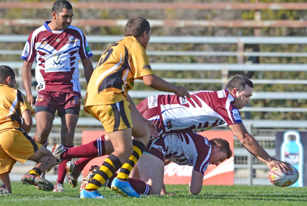 Richard Kennedy dives in to score one of West Lions’ 18 tries on Saturday. Photo: Barry Smith 090814BSE19