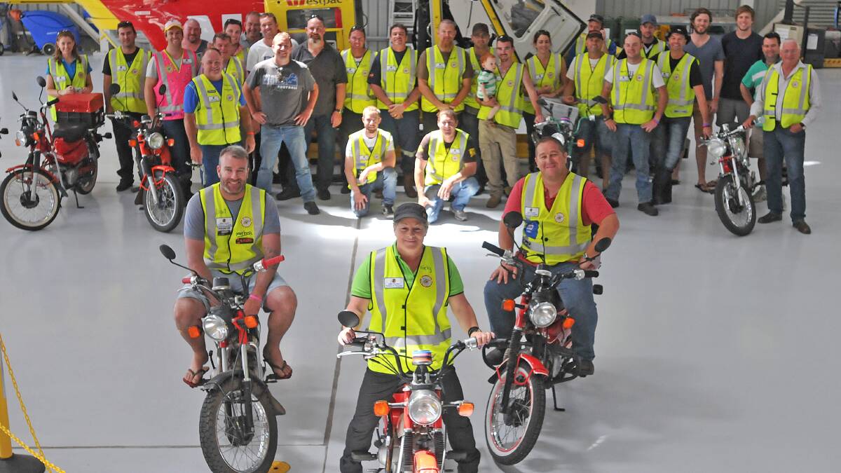 RIDE WITH PRIDE: Stuart Griffen, Nicky Mullen, Clint McSpedden and fellow riders and supporters take a tour of the Westpac Rescue Helicopter Service hangar in Tamworth yesterday. Photo: Geoff O’Neill 140314GOCO1