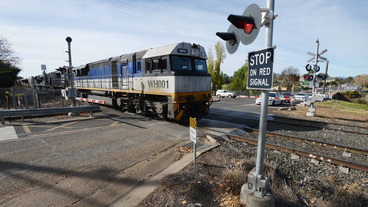 LONG LINES: Another coal train passes through the Quirindi town centre railway crossing. 040614BSC03 