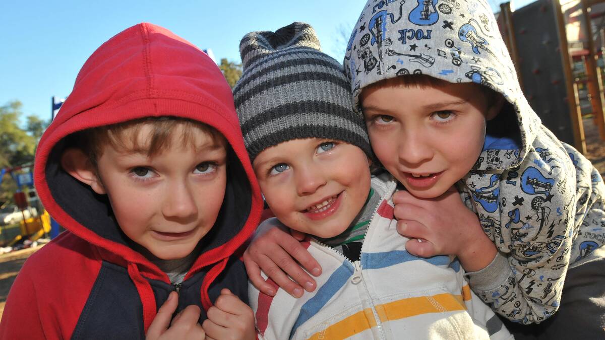 COLD KIDS:  From left, Tom Horan-Roser, 8,  Alex Ross, 3, and Toby Ross, 7, were rugged up for the cold day in Tamworth yesterday at Anzac Park.  Photo: Geoff O’Neill 080714GOF01