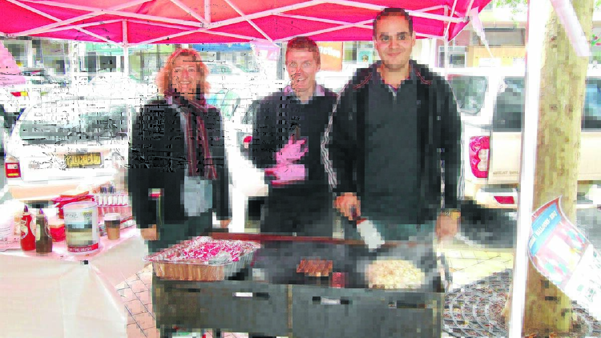 FOR THE BUSH: PRD Nationwide Tamworth real estate agents Simone Upton, Riley Gibson and Mark Sleiman man the barbie at Saturday’s drought fundraiser.