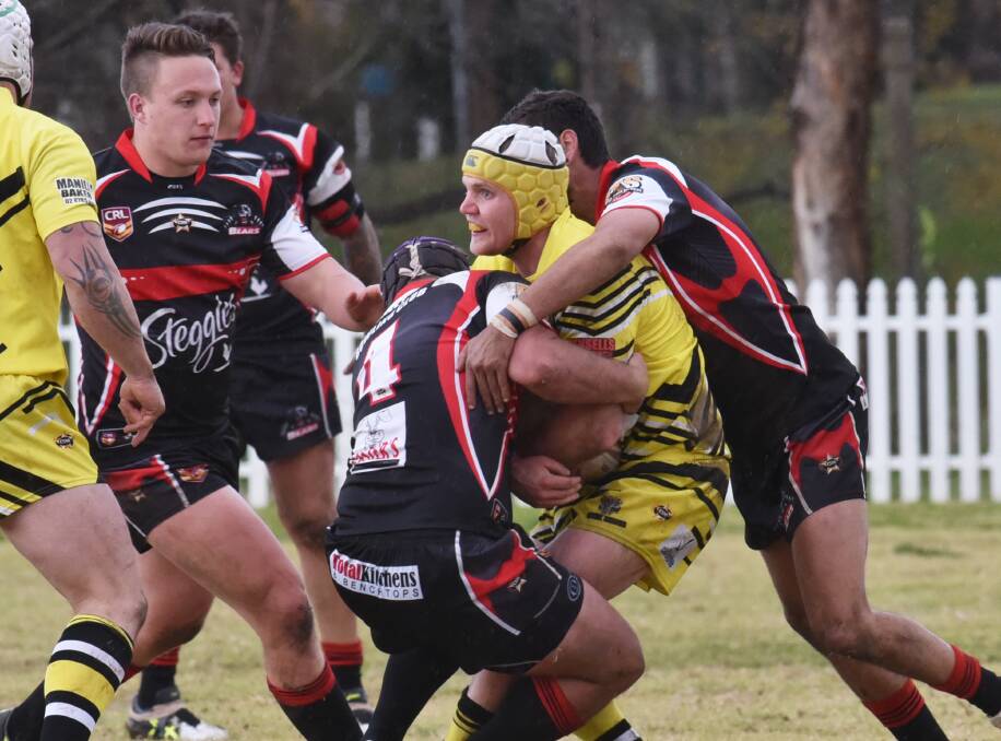 Bear defenders Zac Russ (4) and Stephen Graham (right) smother Diggers centre Will Saunders as Bears backrower James Cooper moves in to lend a hand in yesterday’s 46-nil win. Photo: Geoff O’Neill 120715GOD07