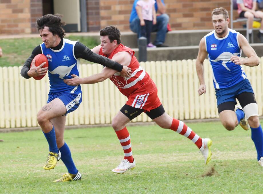 Tamworth Kangaroo Ryan Painter on the run and trying to evade Jack Abbott’s tackle as WA Roo recruit Ben Mitchell (right) lends Painter some support in Saturday’s big win. Photo: Geoff O’Neill 180415GOD02