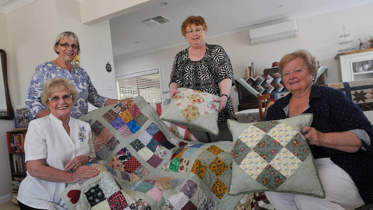 ALL STITCHED UP: Hospital auxiliary members Beth Larkham, left, Bev Barnsley, Annette Burton and president Maureen Sampson, are preparing for their inaugural quilt show. Photo: Gareth Gardner 271014GGB03