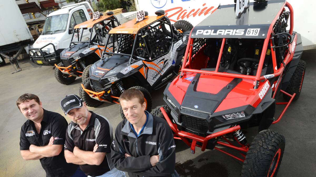 IF AT FIRST YOU DON’T SUCCEED: Driver Ian Hughes, left, team owner and driver Phil Swindale and chief mechanic Daniel Manwaring with the Polaris racing machines. On Tuesday they’ll be heading to the Tatts Finke Desert Race for a second attempt at glory. Photo: Barry Smith 270514BSD01