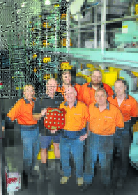 PRESS PEOPLE: Roger Adams, Craig Jenner, David Engert, David Hedges with plaque, Craig Deaton, Mick Smithers and Stephen McDougall were among the print tradesmen who worked on the publications. Photo: Geoff O’Neill 280514GOE02
