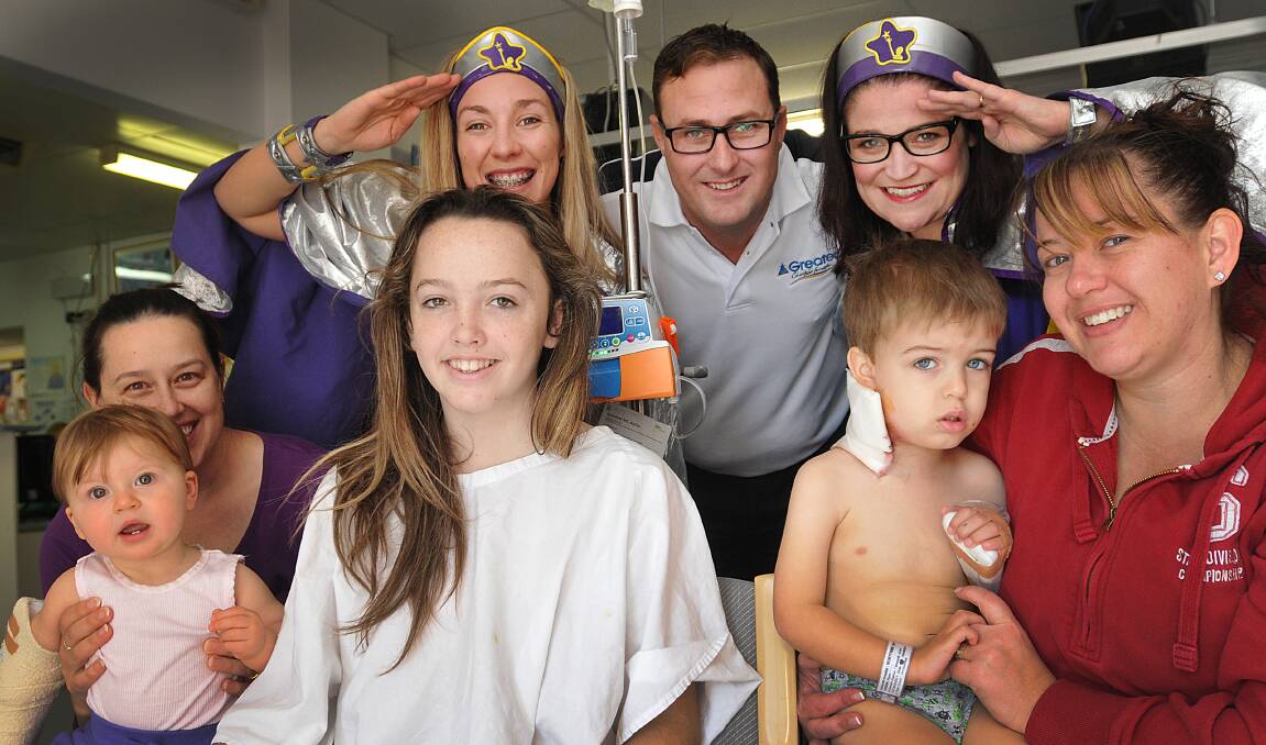 WE SALUTE YOU: The Captains Starlight with, from left, Samantha Bailey and nine-month-old Arizona, 13-year-old Bronte Condon, The Greater’s Tamworth lending manager Dwayne Marshall, Flynn Dodson, 3, and mum Angela. Photo: Geoff O'Neill 180614GOA01