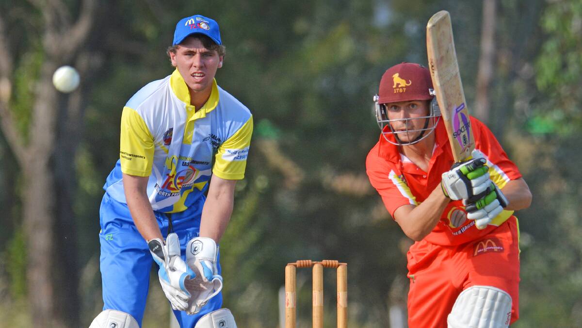 Skipper on skipper... McDonald's captain Adam Mansfield drives in his 15-run innings while Hurricane skipper Matt Everett (keeping) looks on during Friday's second round clash at Riverside 2. Photo: Barry Smith 141114BSC05