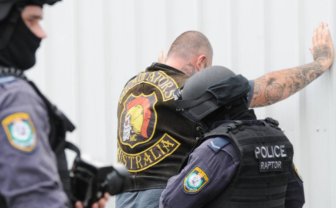 RAIDED: Gunnedah's Gladiators outlaw motorcycle gang member being searched by police on Friday. Photo: Gareth Gardener 040414GGE19
