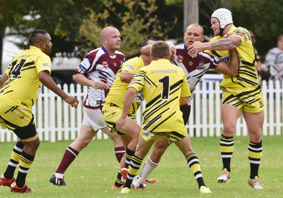 Kyle Cochrane hits the ball up for West Lions in last Saturday’s 112-10 thumping of Oxley Diggers. Teammate Dan O’Neill lurks in the background as Scott Berry (1) worries how he’s going to help coach Jamie Trindall (right) and a teammate stop the charging Cochrane. Photo: Geoff O’Neill 180415GOE03