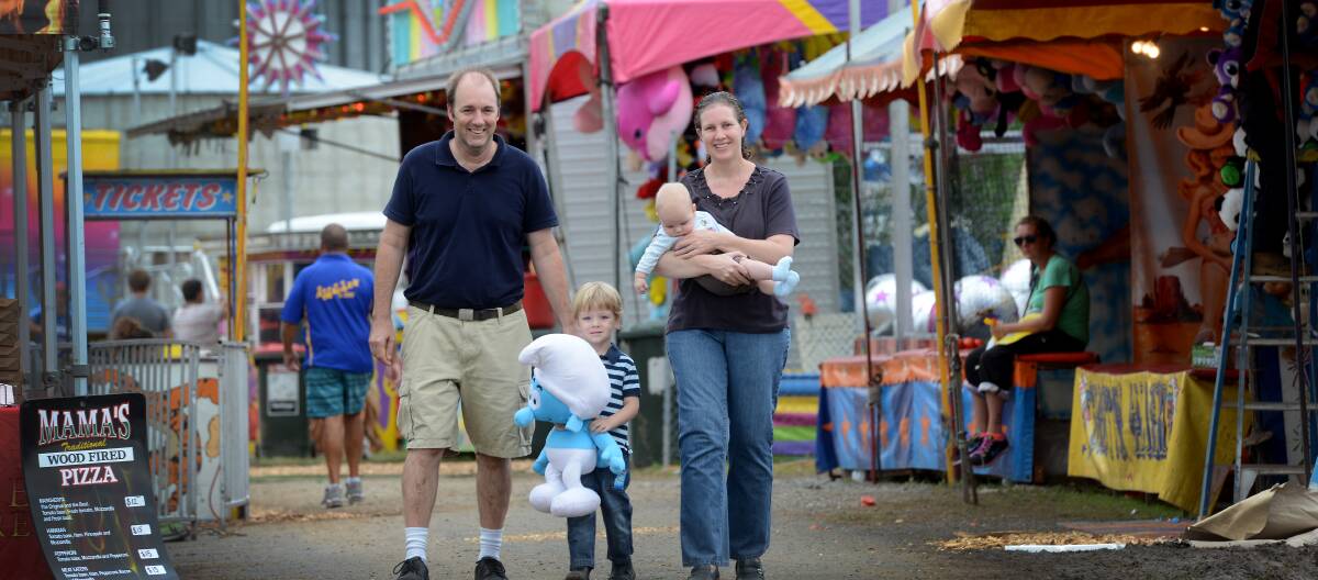 IN SIDESHOW ALLEY: Andrew and Karen Cruickshank, with sons Brayden, 3, and Cooper, six months, at the Tamworth Show. Photo: Gareth Gardner 280314GGD05