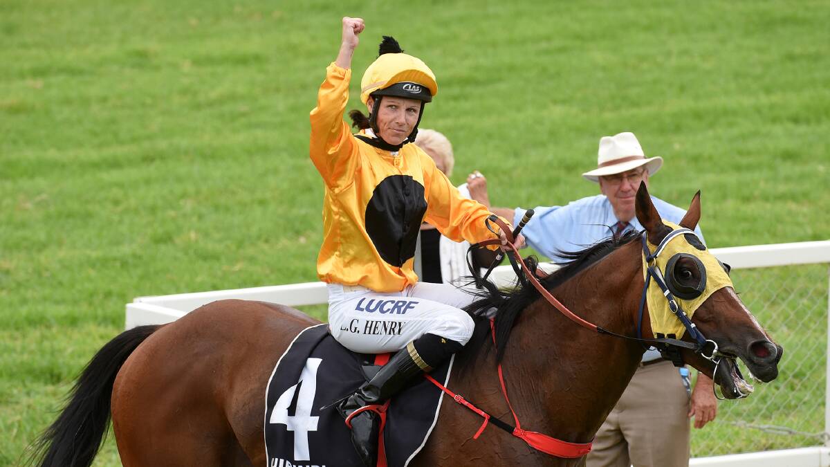 Leanne Henry gives a victory salute after adding the Quirindi Cup to Walcha Cup winner Latitat's trophy list. Photo: Gareth Gardner  200215GGG08